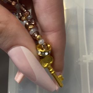 key bracelet with brass and gold accents with white beads